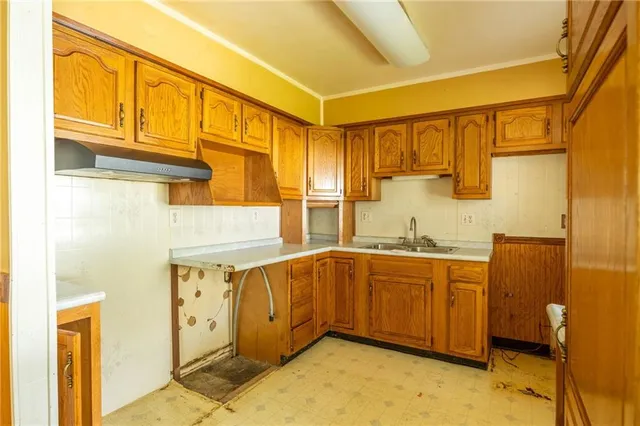 a bathroom with a sink and mirror with bathtub