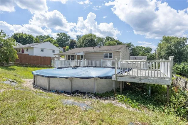 a view of a house with a backyard and a tree