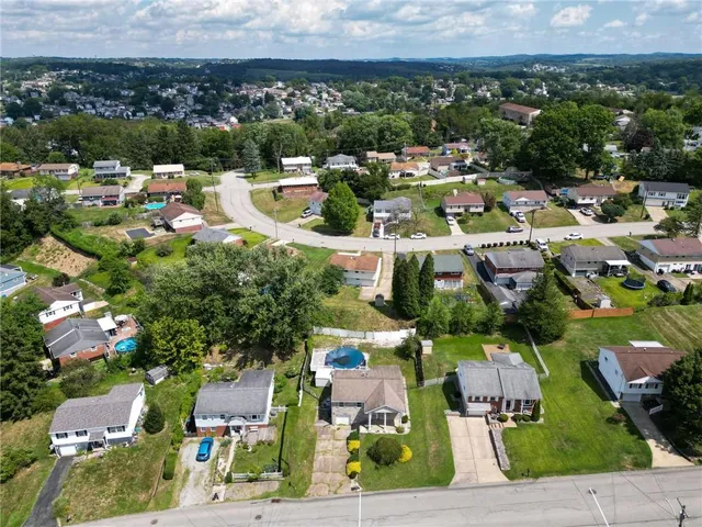 an aerial view of houses with yard