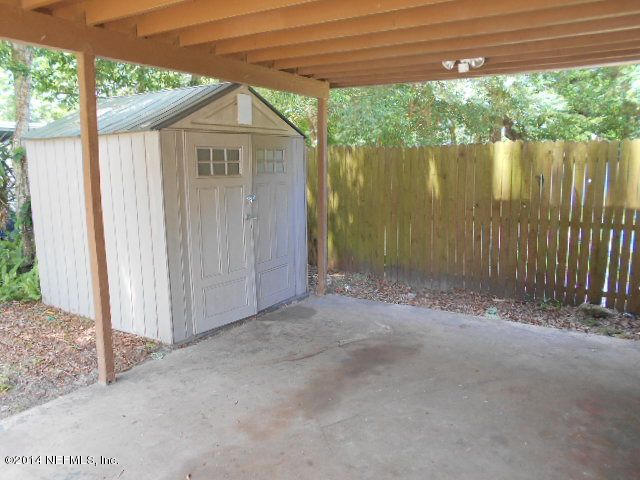 2916 Kent Road Jacksonville, FL 32216 - Photo 3 of 15 a view of a small yard in front of a house with a large tree