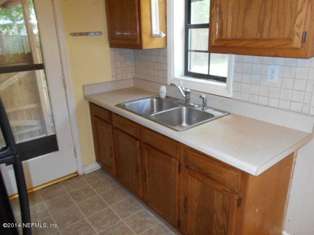 2916 Kent Road Jacksonville, FL 32216 - Photo 7 of 15 a kitchen with sink cabinets and window