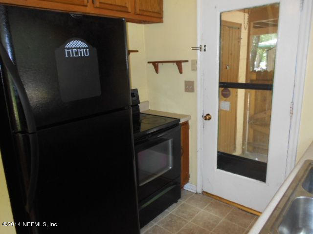 2916 Kent Road Jacksonville, FL 32216 - Photo 8 of 15 a kitchen with a refrigerator and a stove
