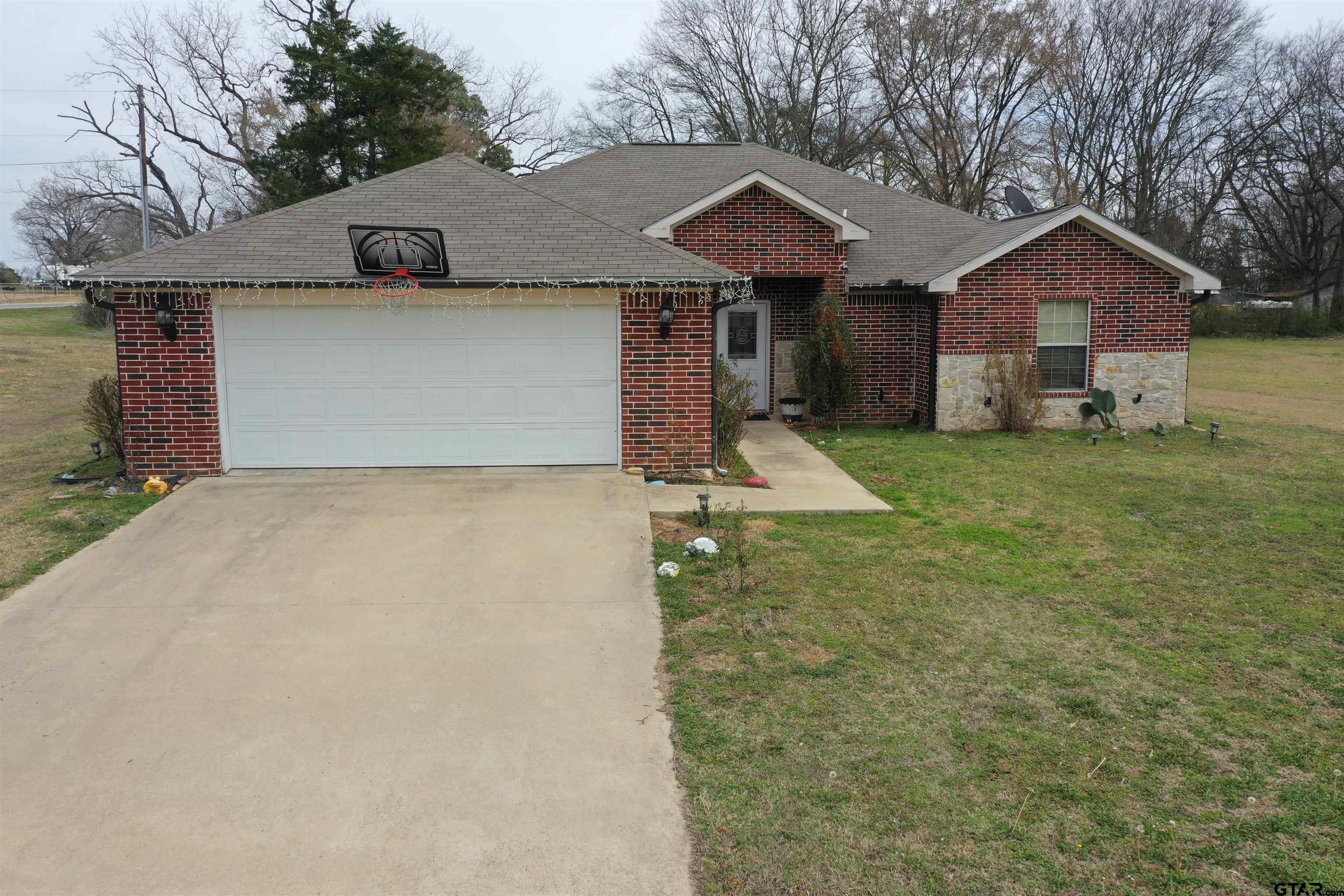 28 County Road 3101 Pittsburg, TX 75686 - Photo 1 of 39 a front view of a house with garden