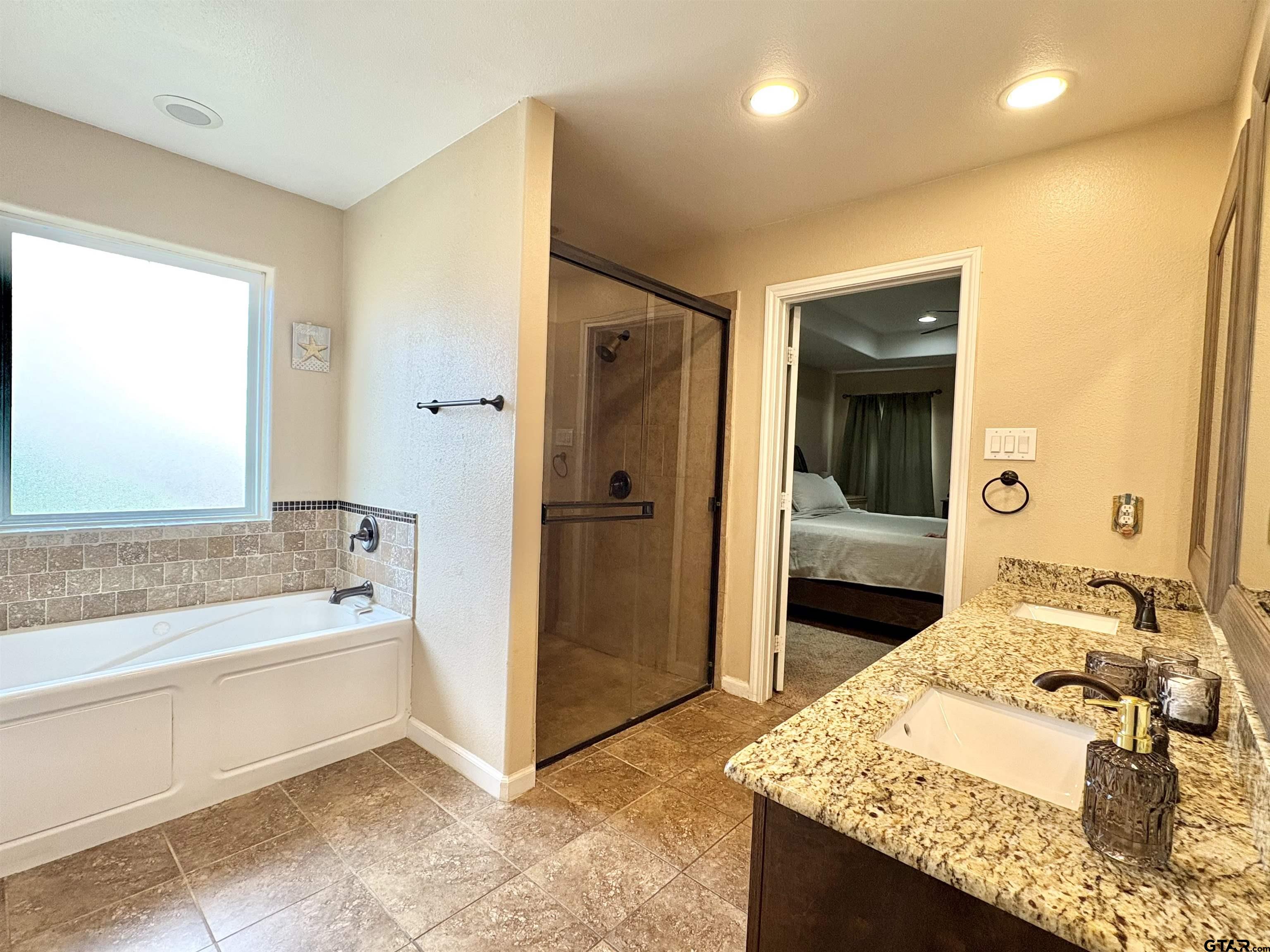 28 County Road 3101 Pittsburg, TX 75686 - Photo 17 of 39 a spacious bathroom with a tub and a sink