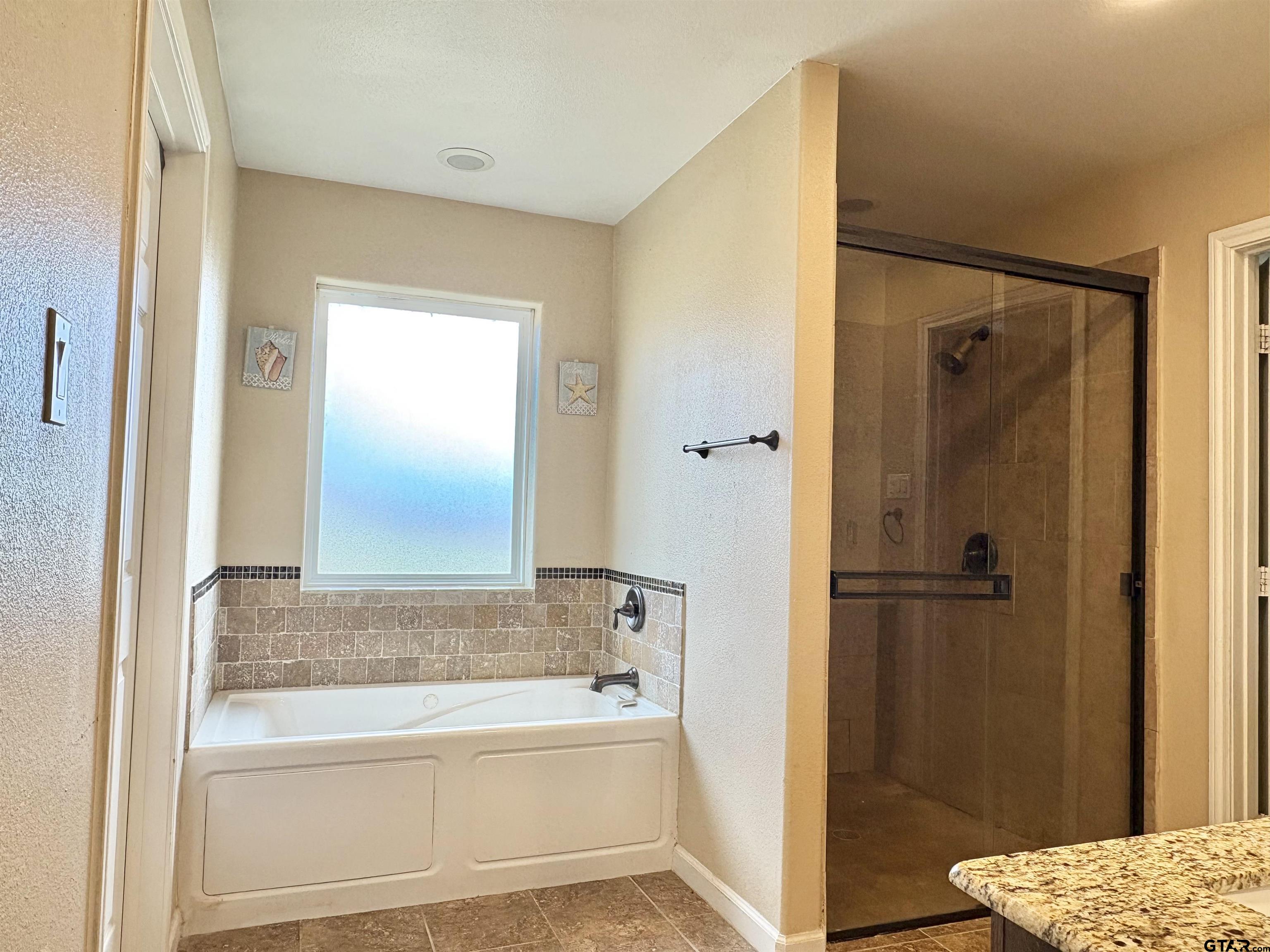 28 County Road 3101 Pittsburg, TX 75686 - Photo 18 of 39 a bathroom with a tub and shower