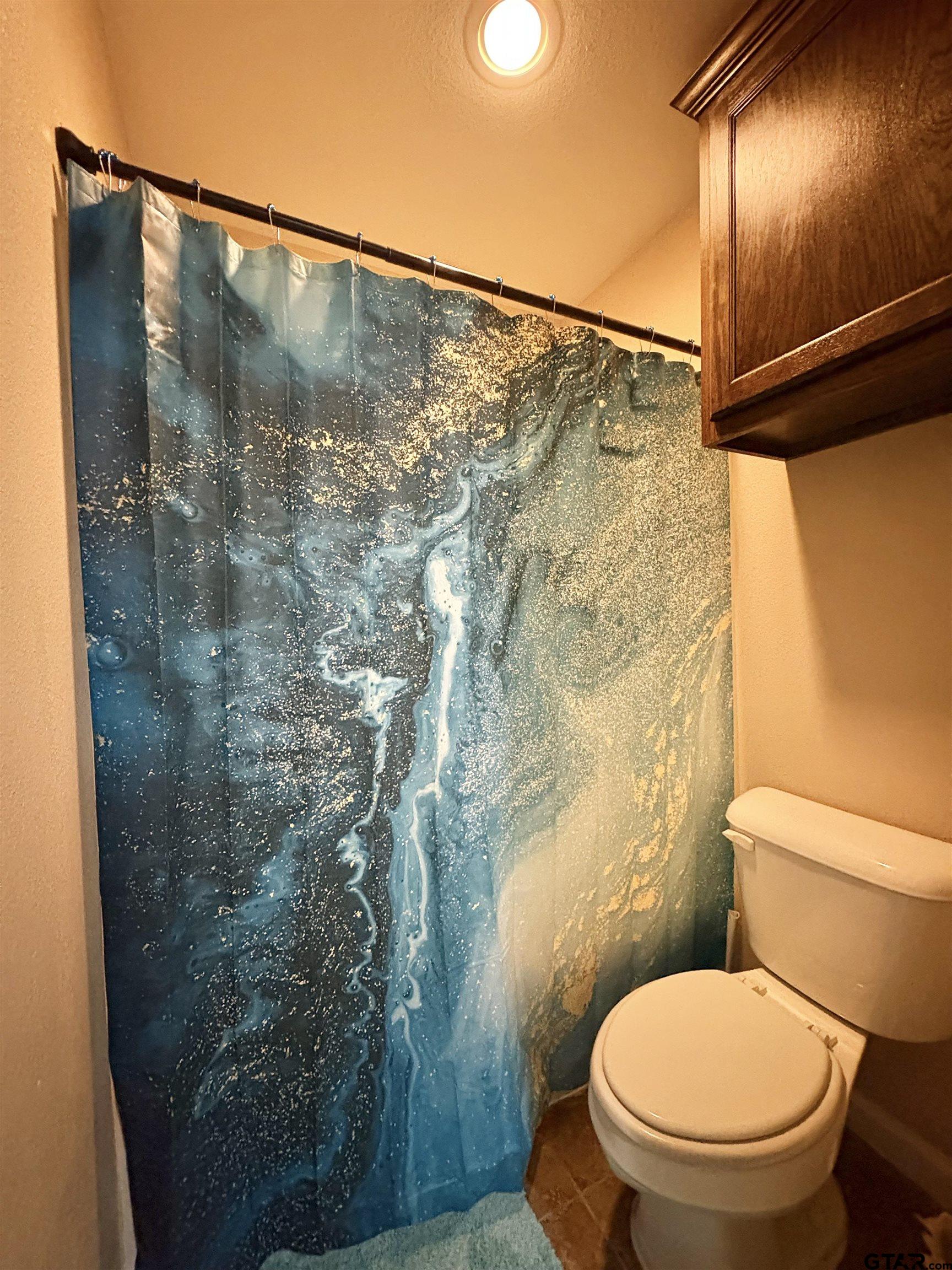 28 County Road 3101 Pittsburg, TX 75686 - Photo 27 of 39 a bathroom with a toilet and a shower