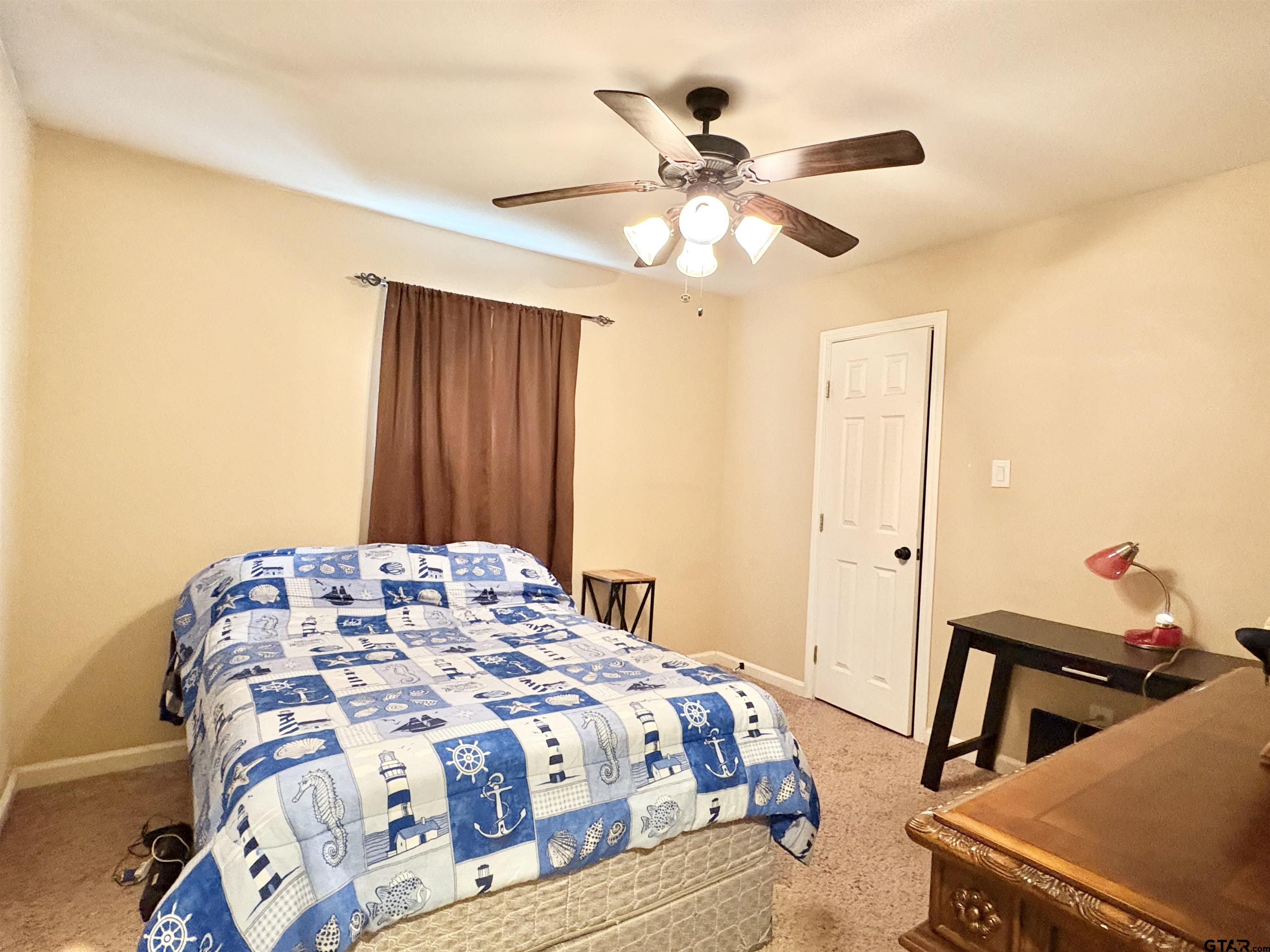 28 County Road 3101 Pittsburg, TX 75686 - Photo 29 of 39 a bedroom with a bed and a chandelier
