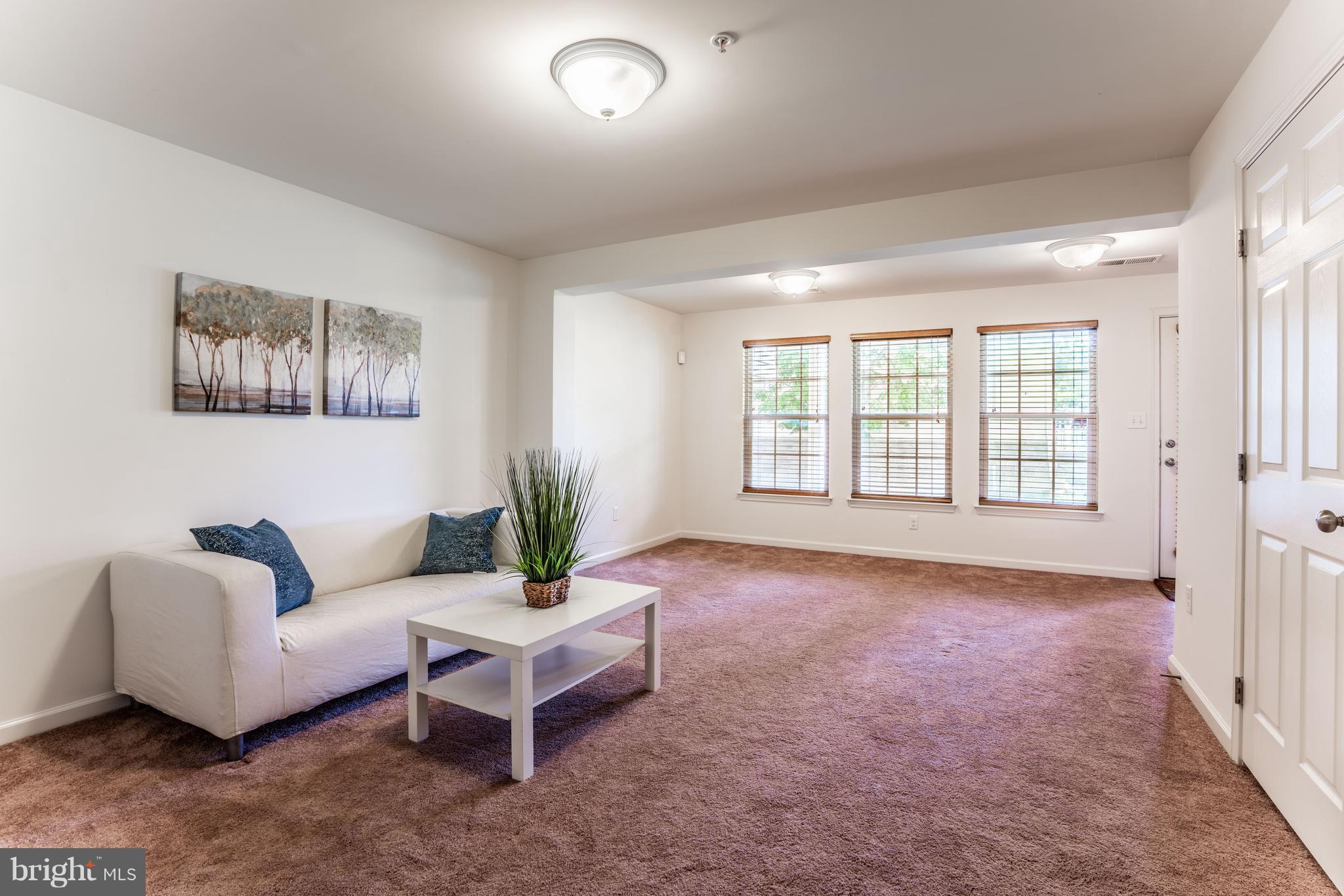 6876 Tasker Falls, Unit 77 Elkridge, MD 21075 - Photo 11 of 30 a living room with furniture and windows