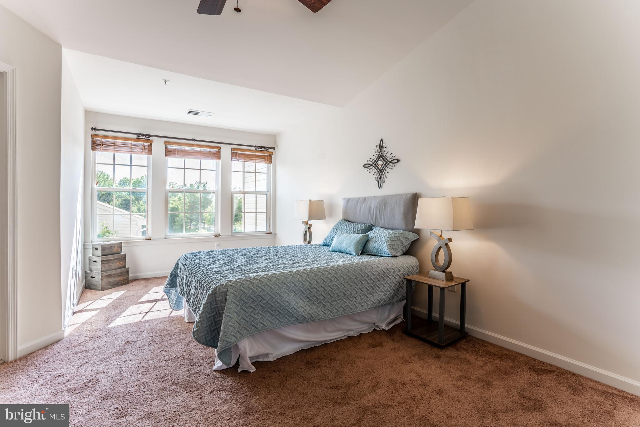6876 Tasker Falls, Unit 77 Elkridge, MD 21075 - Photo 13 of 30 a bedroom with a bed and a window
