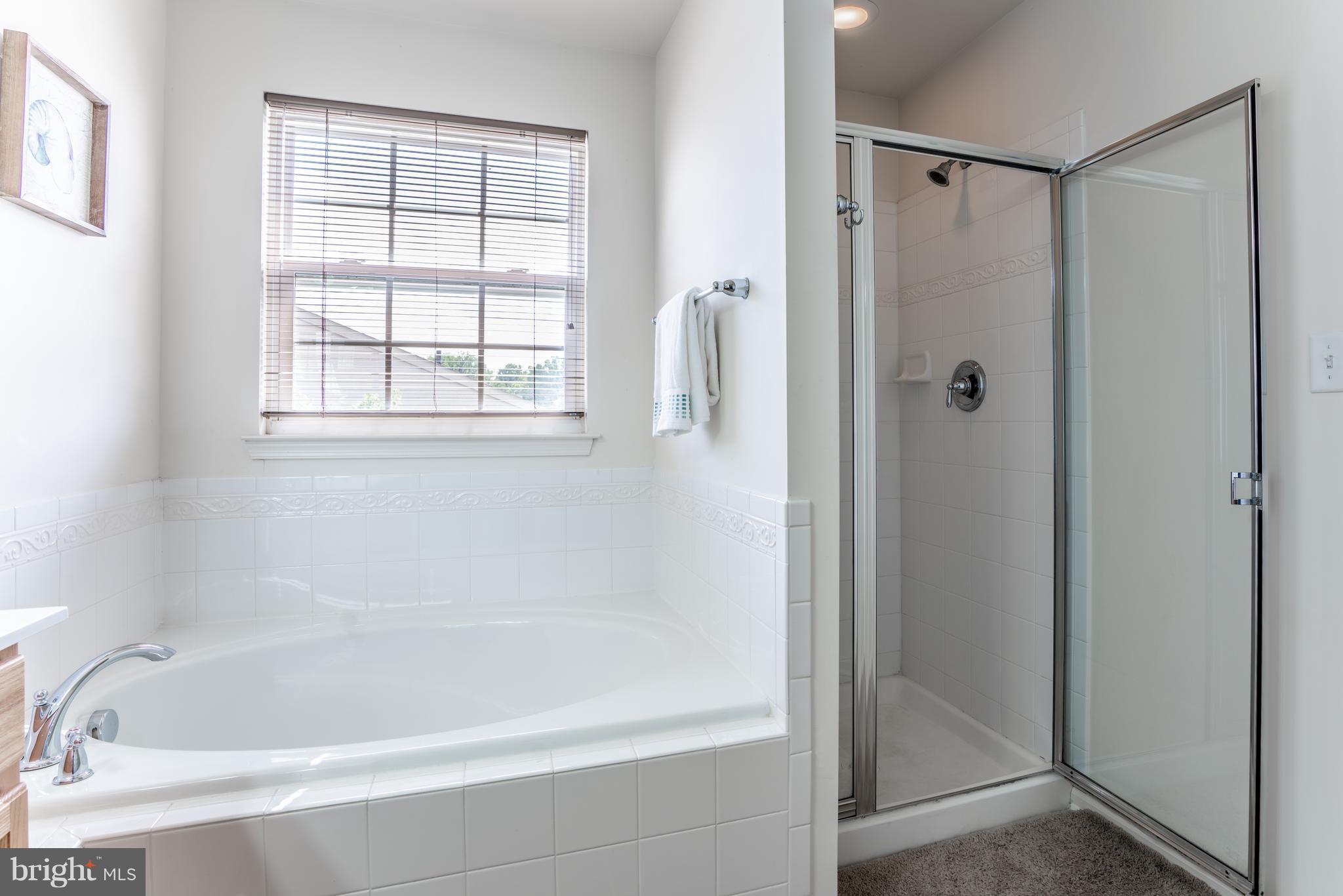 6876 Tasker Falls, Unit 77 Elkridge, MD 21075 - Photo 18 of 30 a bathroom with a tub and a shower
