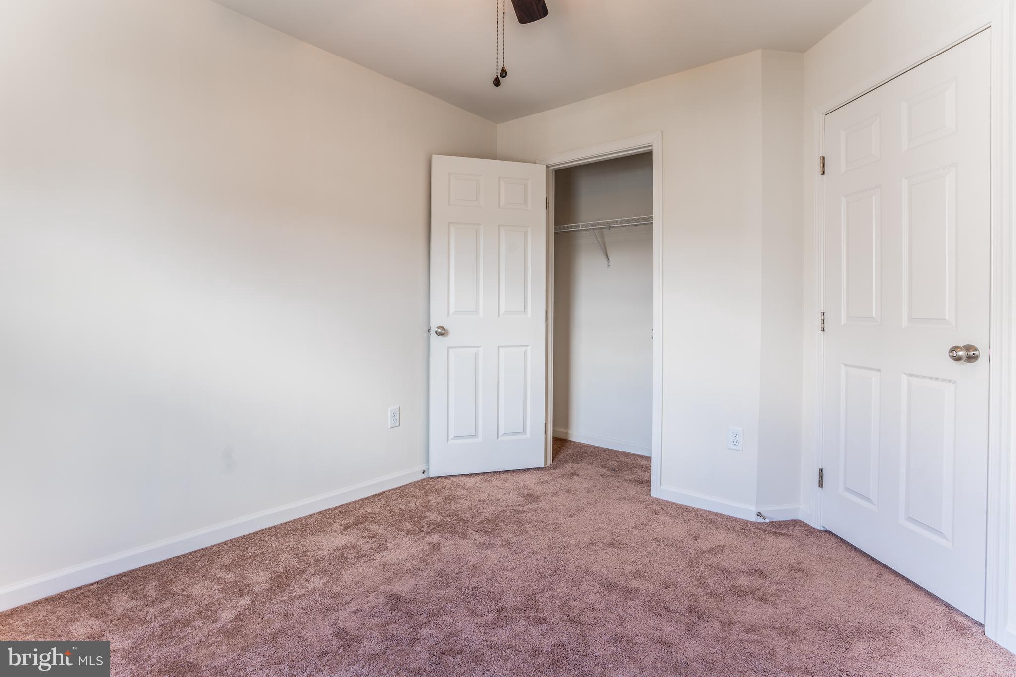 6876 Tasker Falls, Unit 77 Elkridge, MD 21075 - Photo 23 of 30 a view of an empty room with a window