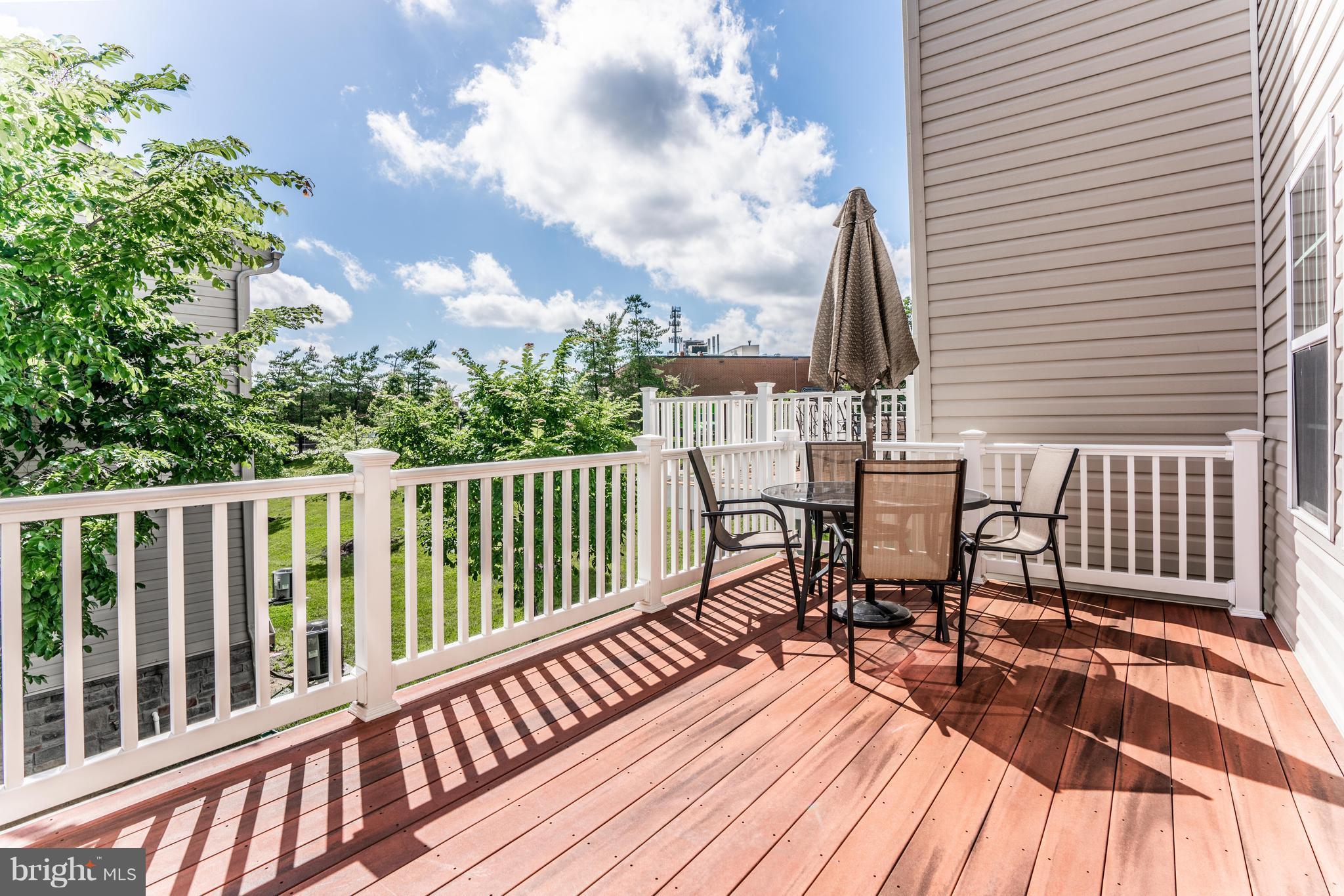 6876 Tasker Falls, Unit 77 Elkridge, MD 21075 - Photo 26 of 30 a view of a chairs on wooden deck