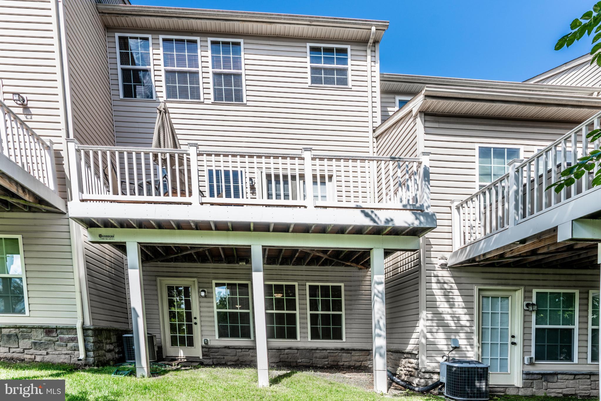 6876 Tasker Falls, Unit 77 Elkridge, MD 21075 - Photo 27 of 30 a front view of a house with a yard