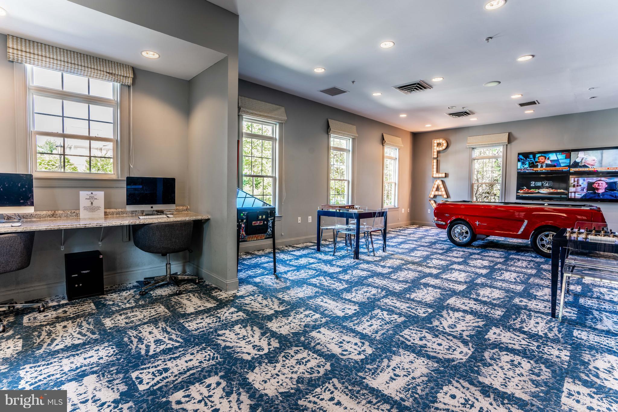 6876 Tasker Falls, Unit 77 Elkridge, MD 21075 - Photo 29 of 30 a living room with furniture a flat screen tv and windows