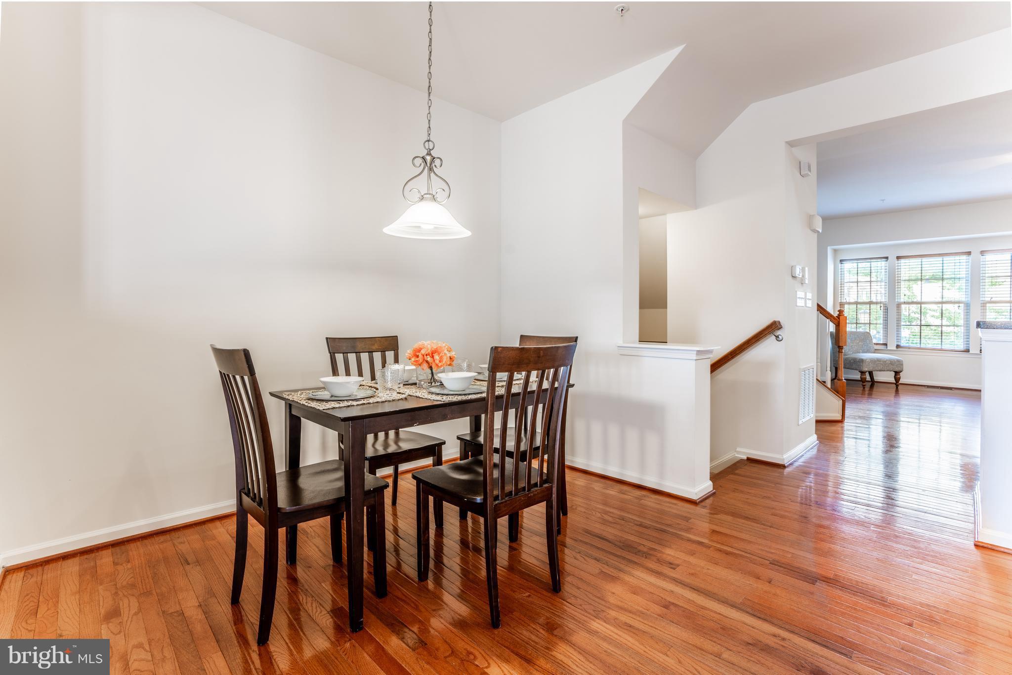 6876 Tasker Falls, Unit 77 Elkridge, MD 21075 - Photo 5 of 30 a view of a dining room with furniture and wooden floor