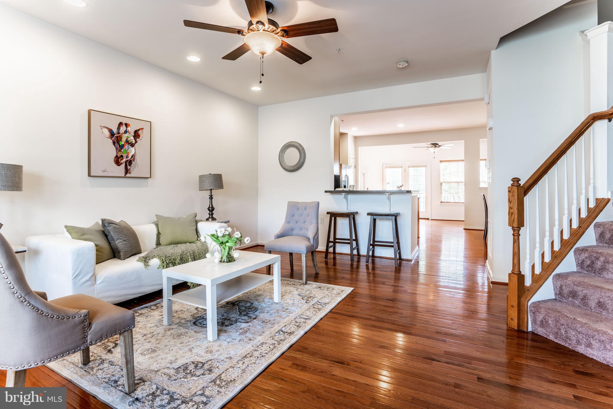 6876 Tasker Falls, Unit 77 Elkridge, MD 21075 - Photo 8 of 30 a living room with furniture and wooden floor