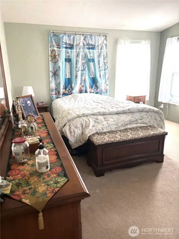 a bed sitting in a bedroom next to a window
