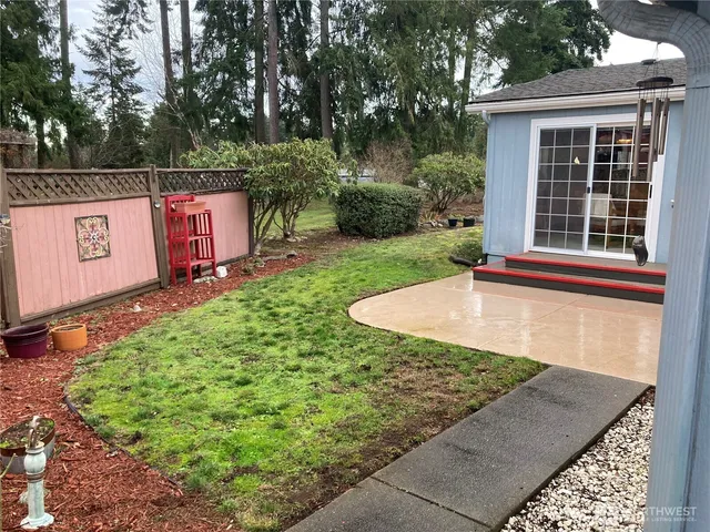 a view of a yard with large trees