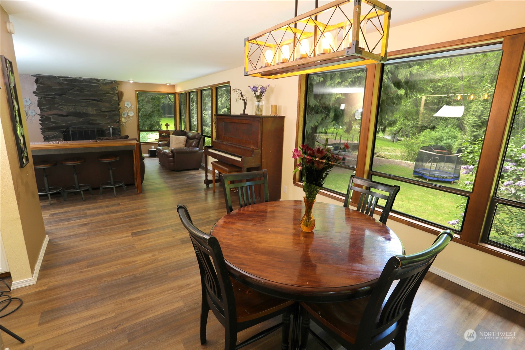 12503 Issaquah-Hobart Road Southeast Issaquah, WA 98027 - Photo 15 of 39 a dining room with furniture a chandelier and wooden floor