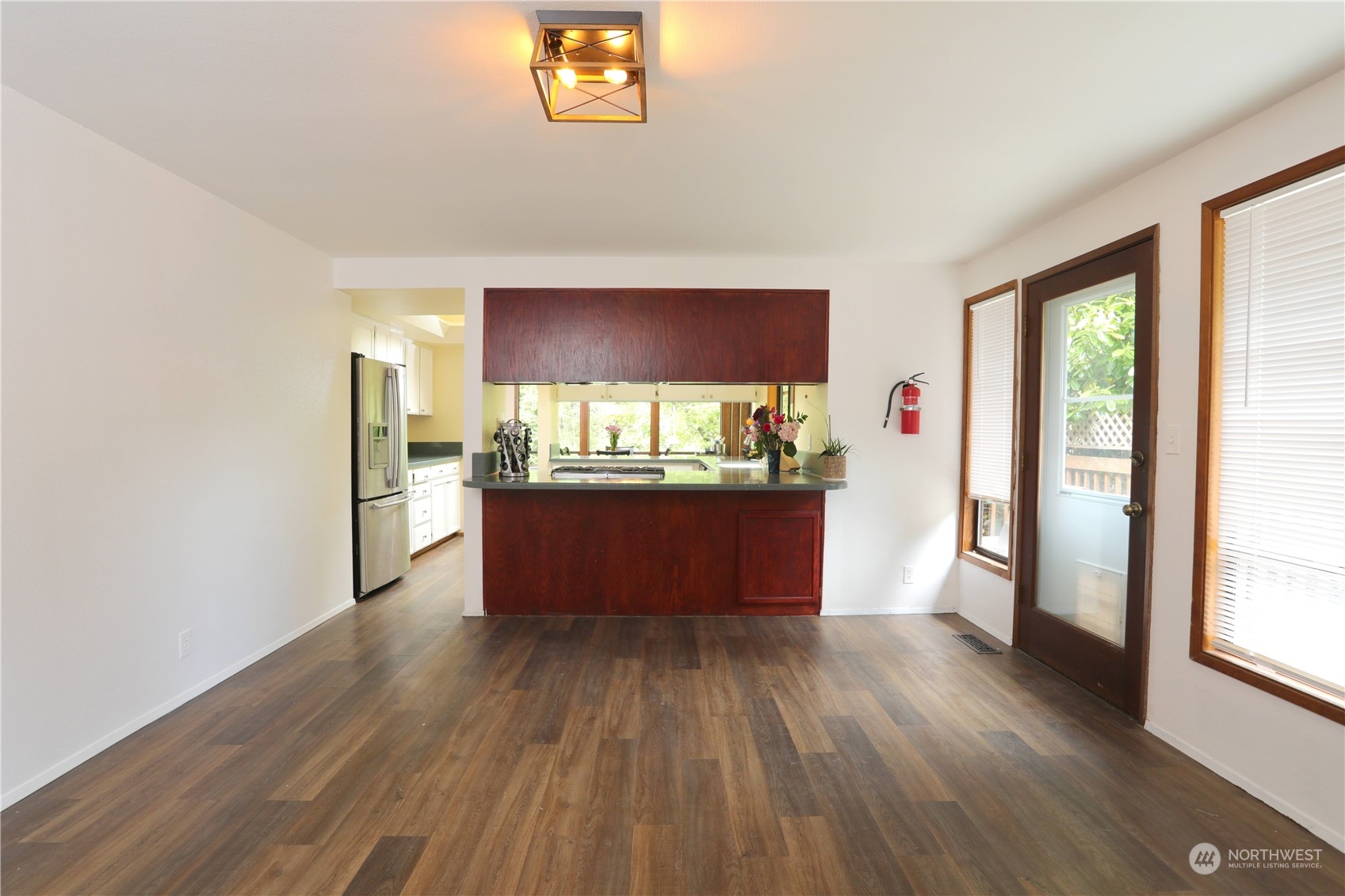 12503 Issaquah-Hobart Road Southeast Issaquah, WA 98027 - Photo 20 of 39 a room with kitchen island wooden floors and wooden cabinets