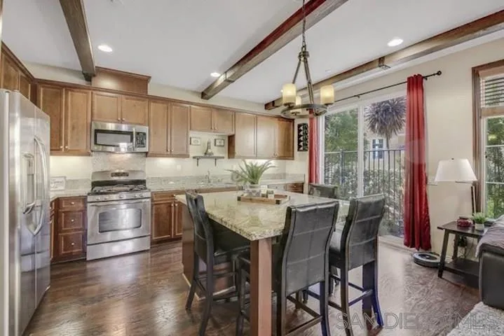 1535 Chert Drive San Marcos, CA 92078 - Photo 4 of 24 a kitchen with stainless steel appliances granite countertop a stove refrigerator and chairs