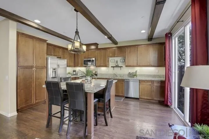 1535 Chert Drive San Marcos, CA 92078 - Photo 5 of 24 a kitchen with a table chairs refrigerator and microwave