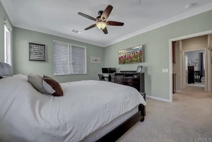 1535 Chert Drive San Marcos, CA 92078 - Photo 9 of 24 a bedroom with a large bed and a chandelier