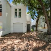 a view of a house with a tree in front