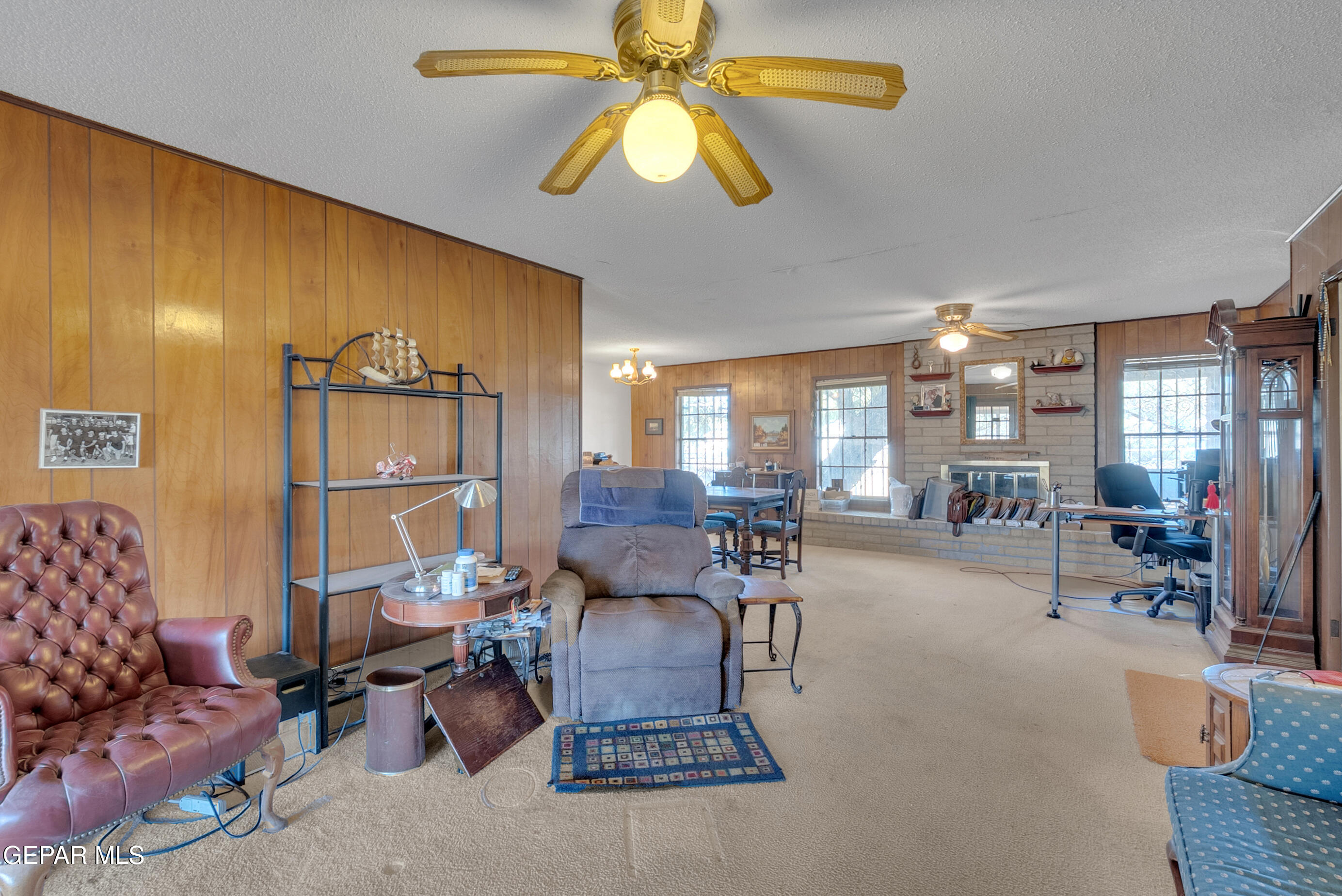 299 Tranquility Road Canutillo, TX 79835 - Photo 4 of 55 a living room with furniture and a chandelier