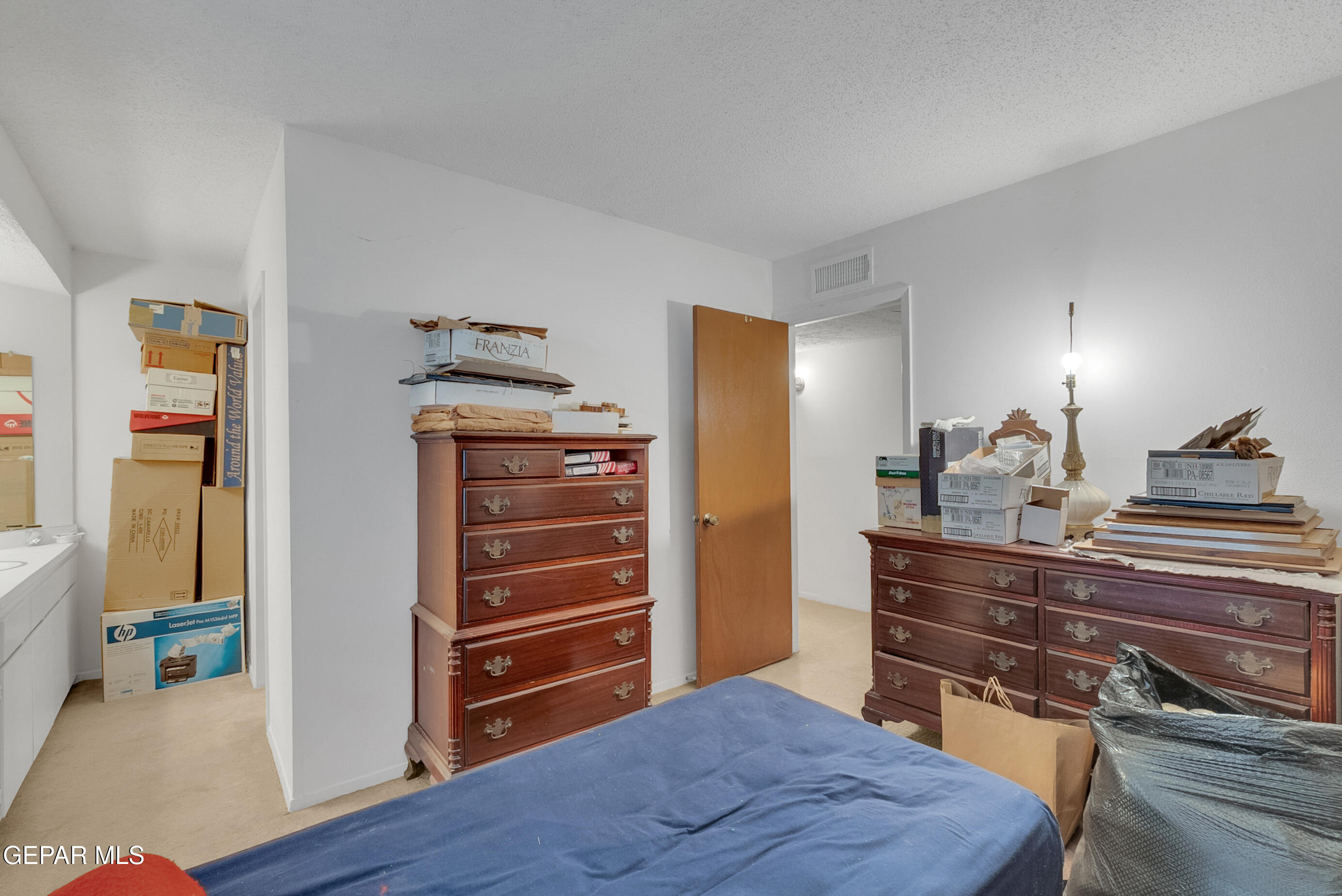 299 Tranquility Road Canutillo, TX 79835 - Photo 41 of 55 a bedroom with a bed and wooden floor