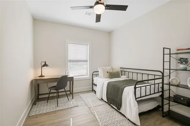 a bedroom with a bed and a desk