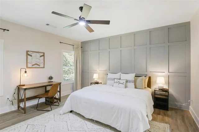 a bedroom with a bed a desk and chair