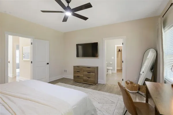 a bedroom with furniture and a flat screen tv