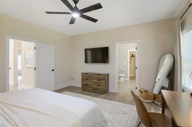 a bedroom with furniture and a flat screen tv