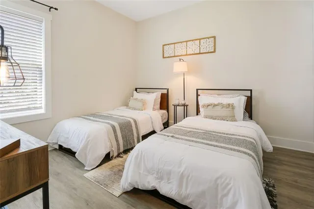 a bedroom with two beds and a night stand