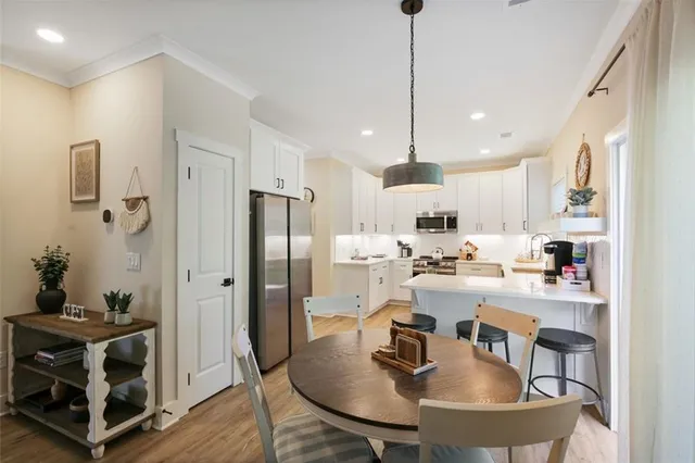 a kitchen with stainless steel appliances granite countertop a sink a stove and refrigerator