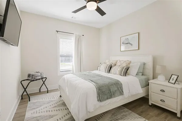 a bedroom with a bed and a flat screen tv