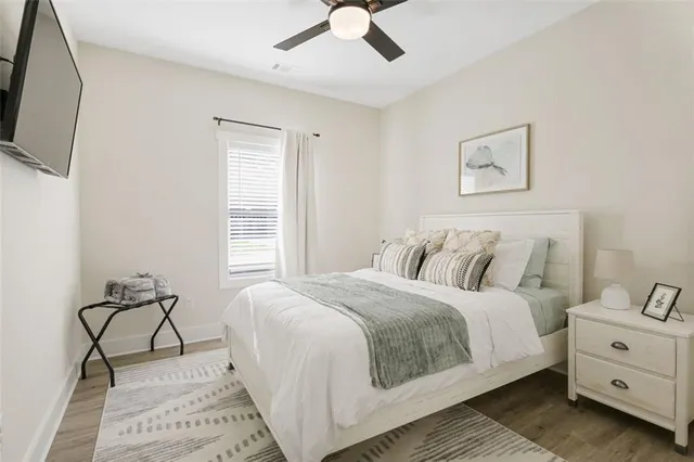 a bedroom with a bed and a flat screen tv