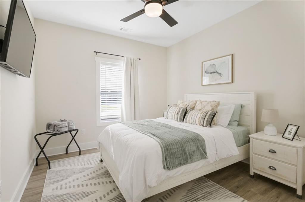 4620 Timrose Road Northwest Kennesaw, GA 30144 - Photo 21 of 30 a bedroom with a bed and a flat screen tv