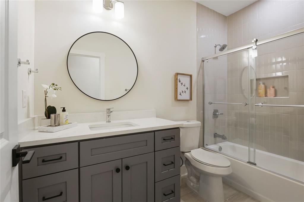 4620 Timrose Road Northwest Kennesaw, GA 30144 - Photo 23 of 30 a bathroom with a toilet a sink a mirror and a shower