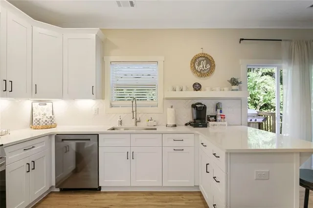 a kitchen with granite countertop white cabinets and white appliances