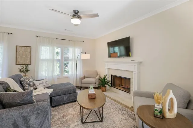 a living room with furniture a fireplace and a flat screen tv