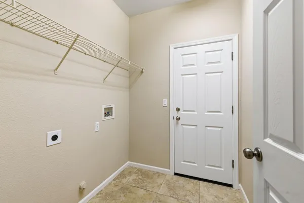 a bedroom with a bed and a potted plant
