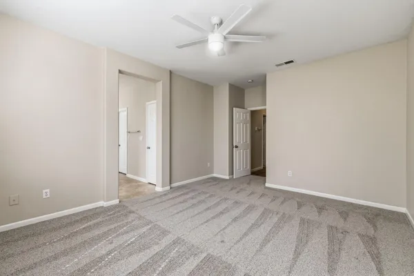a bathroom with a toilet a sink a mirror a bathtub and vanity