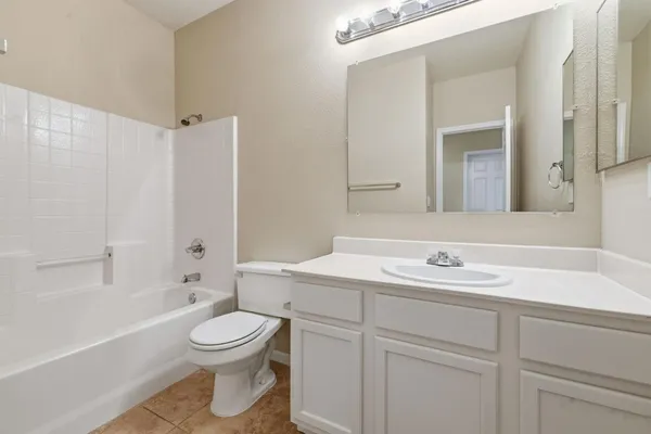 a spacious bathroom with a double vanity sink a mirror and a shower
