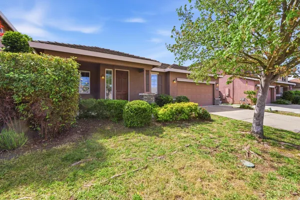a front view of a house with garden