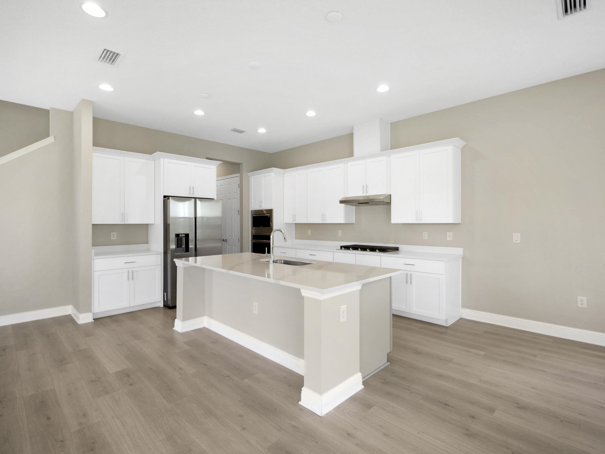 471 Rum Runner Way St. Johns, FL 32259 - Photo 12 of 42 a kitchen with white cabinets and stainless steel appliances