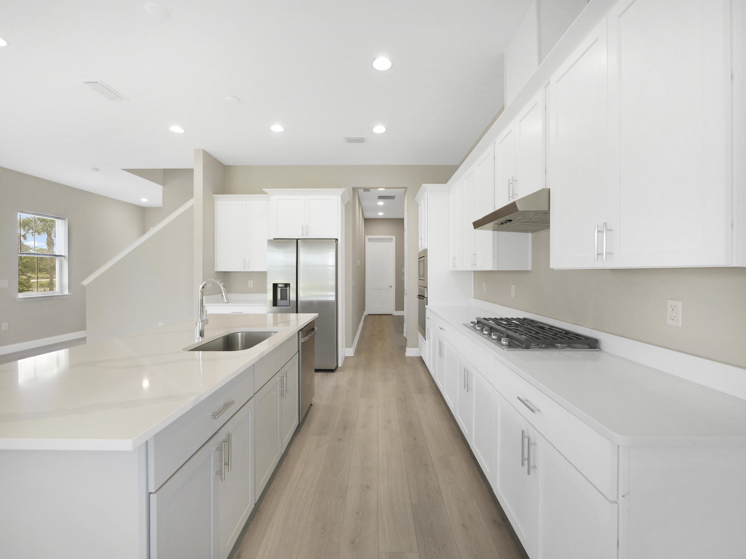 471 Rum Runner Way St. Johns, FL 32259 - Photo 13 of 42 a large kitchen with stainless steel appliances granite countertop a lot of counter space a sink and a refrigerator