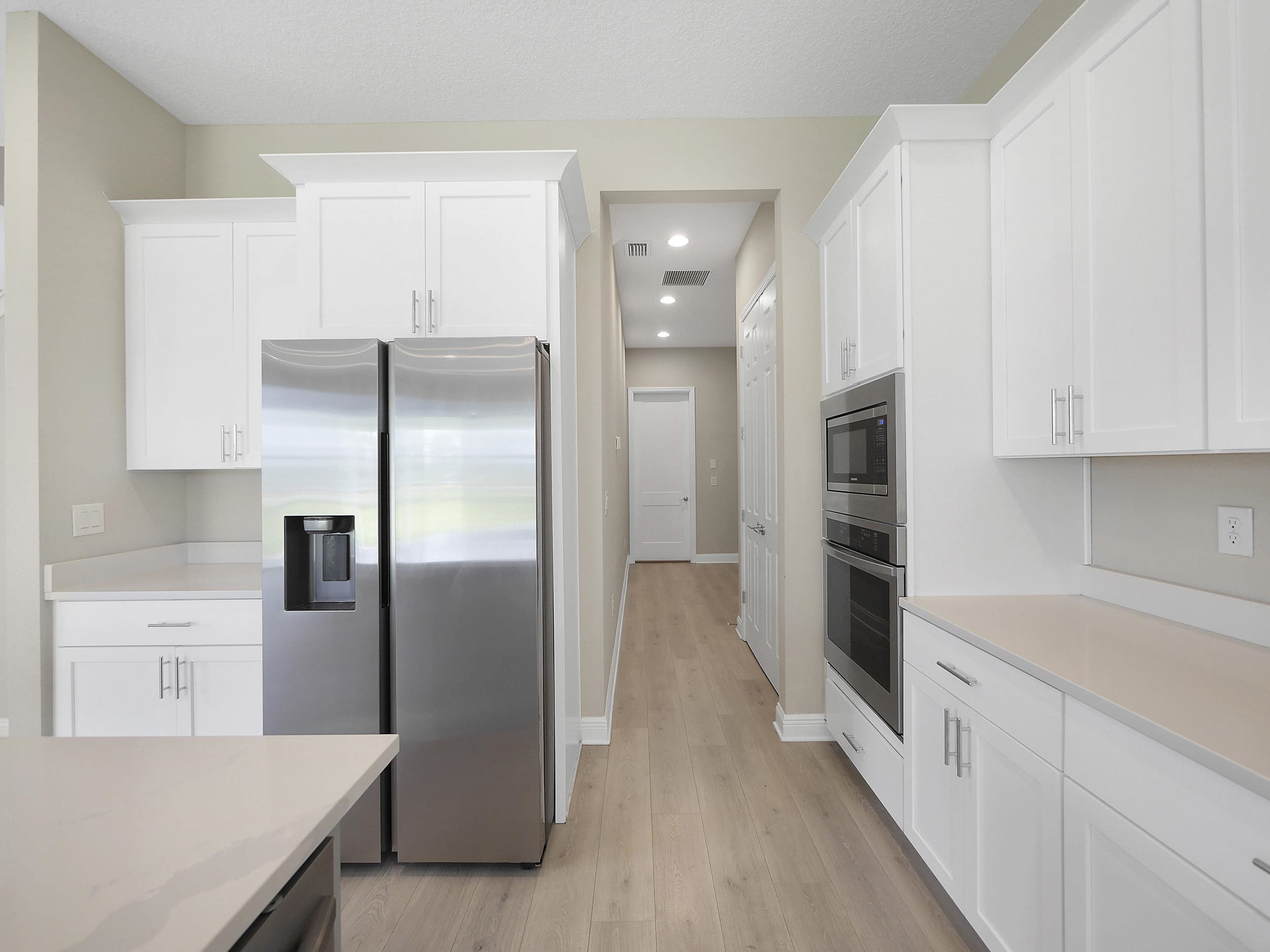 471 Rum Runner Way St. Johns, FL 32259 - Photo 14 of 42 a kitchen with a refrigerator and a sink