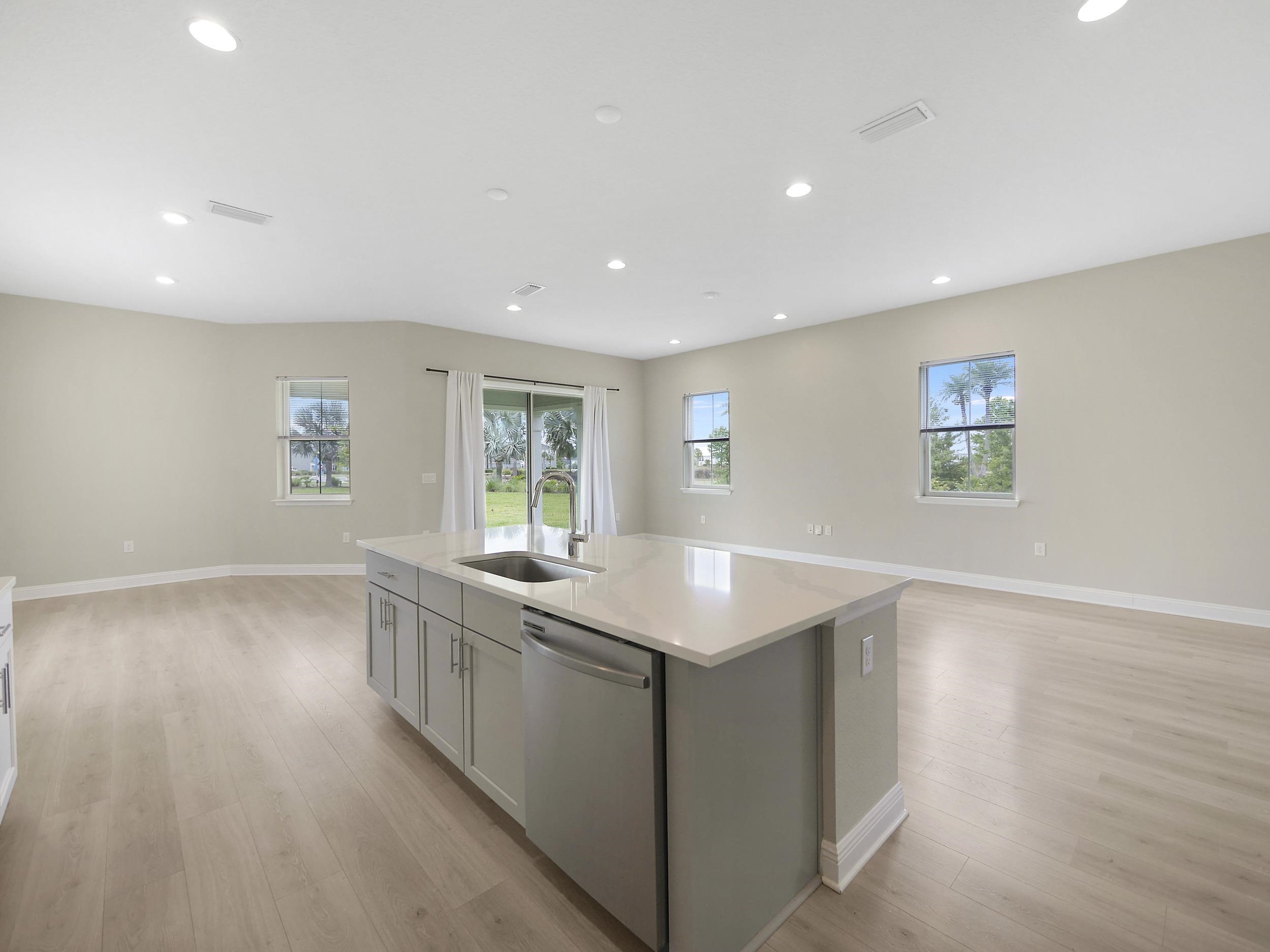 471 Rum Runner Way St. Johns, FL 32259 - Photo 15 of 42 a kitchen with stainless steel appliances granite countertop a sink and a wooden floor
